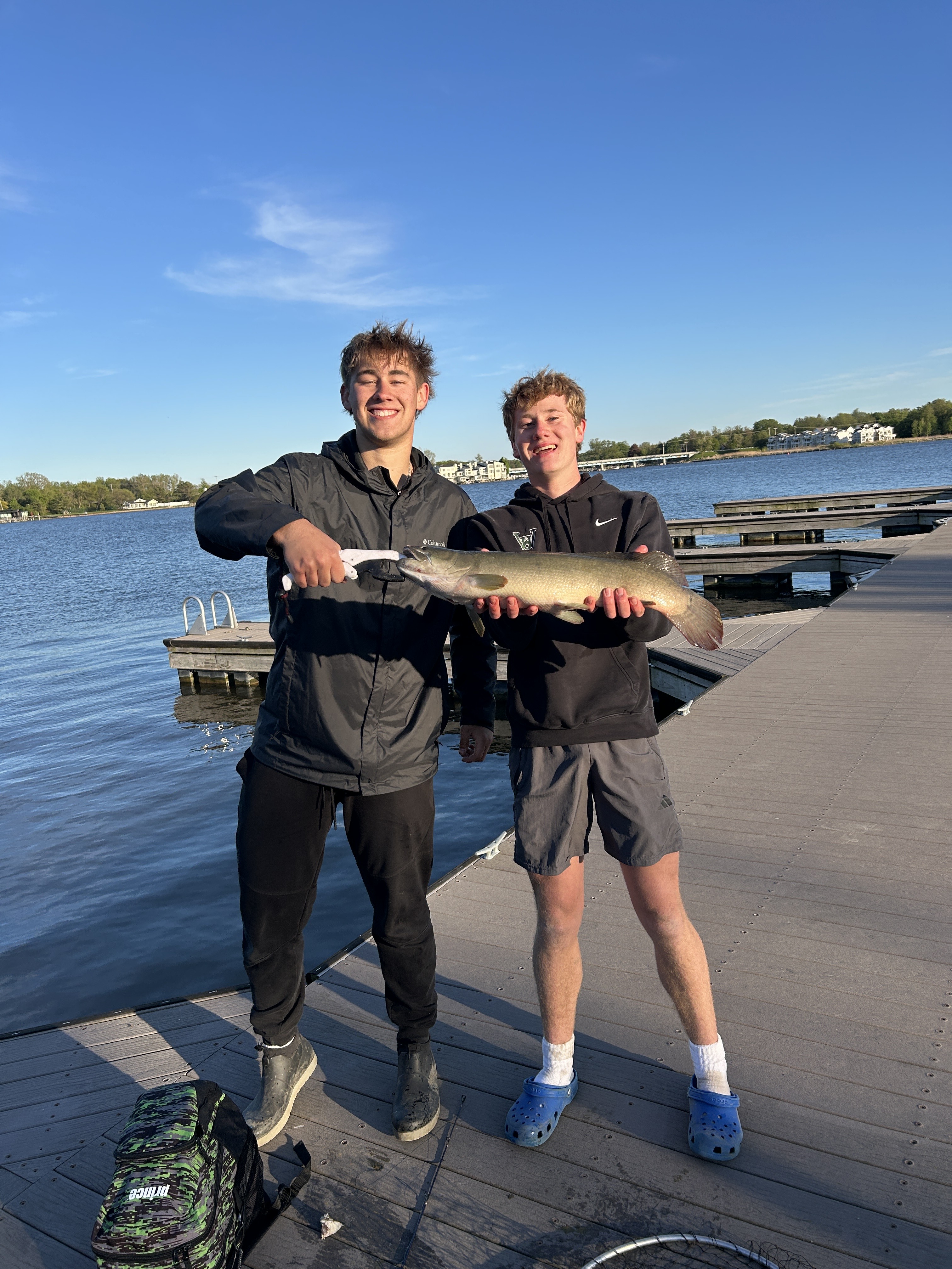 A digital illustration depicting a bullfrog fishing lure, designed to resemble a bullfrog, floating on a lily pad in a pond.